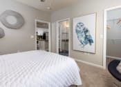 Thumbnail 11 of 40 - a bedroom with a white bed and a painting of an owl at Ansley at Town Center in Evans GA