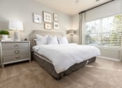 Thumbnail 9 of 40 - a bedroom with a bed and a window at Ansley at Town Center in Evans GA