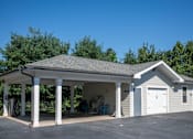 Thumbnail 9 of 30 - A two-story garage with a covered porch.