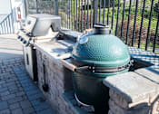 Thumbnail 3 of 30 - A green grill is on a stone platform.