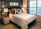 Thumbnail 19 of 30 - A bedroom with a large bed and two lamps.