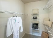 Thumbnail 23 of 30 - A white robe hanging on a rack in a room.