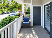 Thumbnail 15 of 30 - A porch with a white railing and a blue chair.