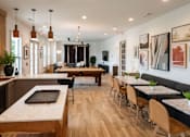 Thumbnail 17 of 26 - A modern kitchen and dining area with wooden floors and furniture.