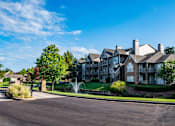 Thumbnail 24 of 30 - an apartment building with a fountain in front of it at Appling Lakes, Tennessee, 38016