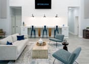 Thumbnail 10 of 18 - a large open living room with a white wall and a large chandelier at Arbors Harbor Town, Memphis, Tennessee