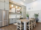 Thumbnail 18 of 18 - A modern kitchen with a wooden table and chairs at Arcadia Cartersville Apartments, Cartersville, Georgia