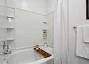 Thumbnail 8 of 18 - A white bathroom with a tub and a shower at Arcadia Cartersville Apartments, Georgia, 30121
