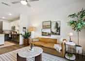 Thumbnail 3 of 18 - A living room with a yellow couch and a white coffee table at Arcadia Cartersville Apartments, Cartersville