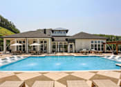 Thumbnail 10 of 18 - A large house with a pool in front at Arcadia Cartersville Apartments, Cartersville, Georgia