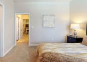 Thumbnail 10 of 36 - a bedroom with a bed in a room at Autumn Park Apartments, North Carolina, 28262