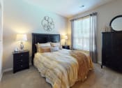 Thumbnail 9 of 36 - a bedroom with a bed and two dressers at Autumn Park Apartments, Charlotte, NC, 28262