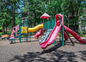 Thumbnail 35 of 36 - Children have a place to run and play at Autumn Park too! Slides, Climbing Equipment and Racetrack at Autumn Park Apartments, Charlotte, NC 28262