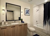Thumbnail 6 of 20 - Bathroom with mirror and wooden cupboard at Azola West Palm Beach, Florida