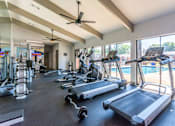 Thumbnail 17 of 23 - A gym with treadmills, elliptical machines, and other exercise equipment. at Brightwaters Apartments, Little Rock, Arkansas