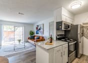 Thumbnail 3 of 23 - A kitchen with a refrigerator, oven, and microwave. at Brightwaters Apartments, Arkansas, 72202