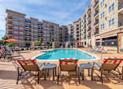Thumbnail 1 of 25 - Pool With Relaxing Chairs at Carson Street Towers, Overland Park