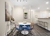 Thumbnail 5 of 42 - Open dining area with round table and breakfast bar at Alden Place at South Square Apartments, Durham