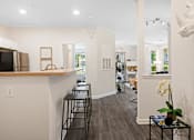 Thumbnail 6 of 42 - Open kitchen with breakfast bar and wood countertop at Alden Place at South Square Apartments, Durham, NC 27707