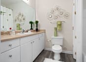 Thumbnail 14 of 42 - Bathroom with white vanity and decorative wall art at Alden Place at South Square Apartments, Durham, NC