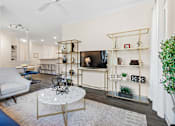 Thumbnail 4 of 42 - Living area with marble coffee table and entertainment center at Alden Place at South Square Apartments, Durham