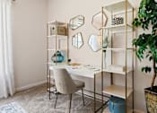 Thumbnail 8 of 42 - Home office with gold shelving and vanity desk at Alden Place at South Square Apartments, Durham, NC 27707