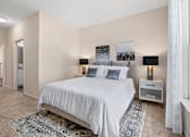 Thumbnail 7 of 42 - Bedroom with vaulted ceiling and matching nightstands at Alden Place at South Square Apartments, Durham, NC