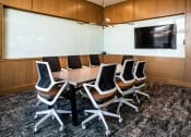Thumbnail 11 of 17 - a small conference room with a table and chairs