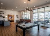 Thumbnail 9 of 17 - a pool table in the clubhouse at the bradley braddock road station apartments