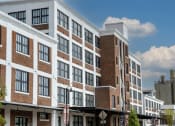 Thumbnail 8 of 23 - a large brick and white building with many windows at Conwood Flats, Memphis