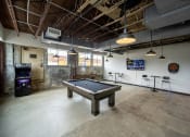 Thumbnail 22 of 23 - a pool table sits in the middle of a room with a tv in the background at Conwood Flats, Memphis, Tennessee