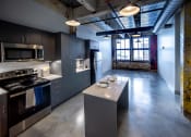 Thumbnail 1 of 23 - a kitchen with a large island and stainless steel appliances at Conwood Flats, Memphis, Tennessee