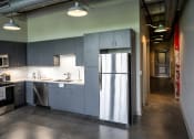 Thumbnail 4 of 23 - a kitchen with gray cabinets and stainless steel appliances at Conwood Flats, Tennessee, 38107