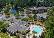 Thumbnail 28 of 29 - A bird's eye view of a resort with a swimming pool and a lake.