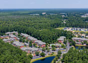 Thumbnail 27 of 29 - A bird's eye view of a residential area surrounded by greenery.