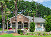 Thumbnail 29 of 29 - A building with a sign that says "Country Man Luxury Apartments" in front of it.
