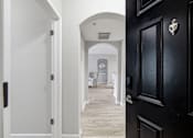Thumbnail 15 of 29 - A black door with a silver handle is on the right side of the image.