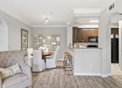 Thumbnail 5 of 29 - A modern kitchen with a dining table and chairs.