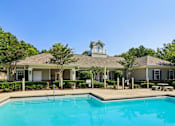 Thumbnail 1 of 33 - A house with a pool in front.
