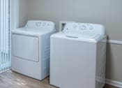 Thumbnail 10 of 20 - Two white front load washing machines in a room. at Dunwoody Glen, Atlanta