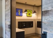 Thumbnail 18 of 34 - Indoor Mail Room with Mailboxes for Residents at Echo at North Pointe Center Apartment Homes, Alpharetta, GA 30009