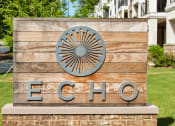 Thumbnail 34 of 34 - Lush landscaping surrounds you as you drive into Echo at North Pointe Center Apartment Homes, Alpharetta, GA 30009