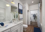 Thumbnail 4 of 34 - Relax in your Stunning Bathroom with Double Vanity Sinks, Subway Tile Showers with Glass Enclosures and Full Length Mirrors at Echo at North Pointe Center Apartment Homes, Alpharetta, GA 30009