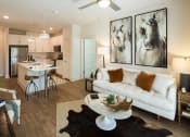Thumbnail 2 of 34 - Open Floor Plans with Plenty of Living Space featuring Barn-Style Lighting and Reclaimed Wood-Inspired Flooring at Echo at North Pointe Center Apartment Homes, Alpharetta, GA 30009