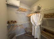 Thumbnail 7 of 22 - A white robe is hanging on a rack in a room at Enclave at Wolfchase Apartments, Memphis