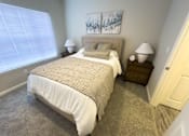 Thumbnail 6 of 22 - A bedroom with a large bed and two nightstands at Enclave at Wolfchase Apartments, Memphis, TN