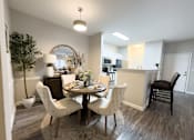 Thumbnail 4 of 22 - A dining room with a round table and chairs at Enclave at Wolfchase Apartments, Memphis