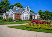 Thumbnail 17 of 22 - A house with a grey roof and a flower bed in front at Enclave at Wolfchase Apartments, Memphis, 38016