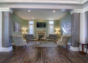 Thumbnail 15 of 22 - A living room with a fireplace and a television at Enclave at Wolfchase Apartments, Memphis, Tennessee