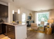 Thumbnail 5 of 21 - Model kitchen and living room at Fifth Street Place Apartments, Charlottesville, VA
